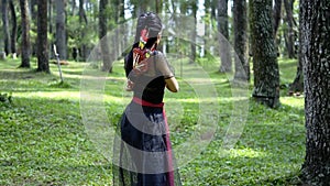 Archery woman hunting an enemy inside the forest with an arrow and a bow