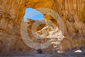 The Arches, amazing round hole in the rock, closed arch in ancient cooper mines canyons and mountains range in Timna National Park