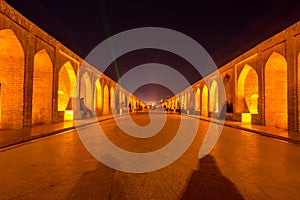 Arches of night view with light effect of Allahverdi Khan Bridge, also named  Si-o-seh pol bridge across the Zayanderud river in