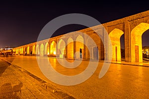 Arches of night view with light effect of Allahverdi Khan Bridge, also named  Si-o-seh pol bridge across the Zayanderud river in