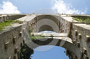 Arches of old stone bridge Ponte Vecchio or Padre Scopetta in Ragusa seen from below, Sicily, Italy