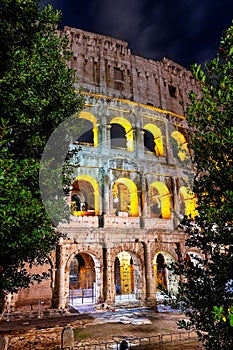 Arches of Rome Colosseum (Flavian Amphiteater) illuminated at night, Rome, Italy