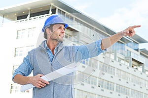 Architect with blueprint pointing away