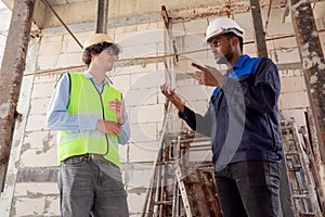 Architect and builder talking and inspector construction at construction site.
