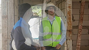 Architect and builder talking and inspector construction at construction site.