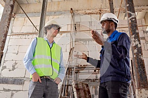 Architect and builder talking and inspector construction at construction site, contractor and worker discussion.