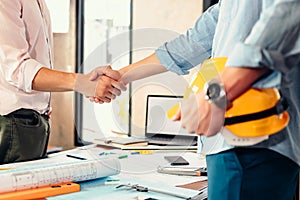 Architect and businessman handshake after finish an agreement in the office at  site construction