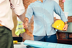 Architect and businessman handshake after finish an agreement in the office at  site construction