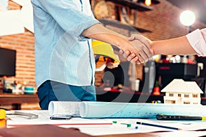 Architect and businessman handshake after finish an agreement in the office at  site construction