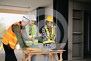 Architect caucasian man and woman working with colleagues mixed race in the construction site. Architecture engineering on big