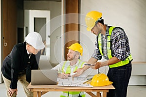 Architect caucasian man working with colleagues mixed race in the construction site. Architecture engineering on big project.