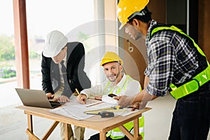 Architect caucasian man working with colleagues mixed race in the construction site. Architecture engineering on big project.