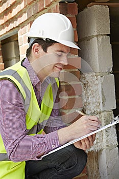 Architect Checking Insulation During Construction Project