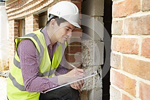 Architect Checking Insulation During House Construction