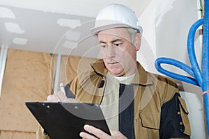 Architect checking insulation during house construction