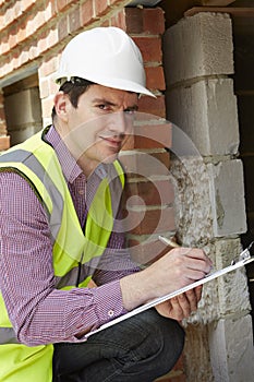 Architect Checking Insulation During House Construction