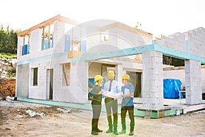 Architects and worker at the construction site.