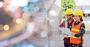 Architect and client discussing the plan with blueprint of the building at construction site