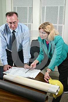 Architect And Client Looking At Blueprints 6