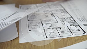 Architect and client at office workplace disscus information about building and working with paper tougether