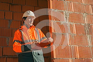 Architect and construction engineer making notes and remarks during building site inspection