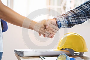 Architect contractor shaking hands with client after seal a deal to renovate building