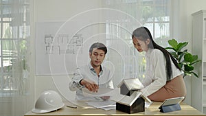architect couple is brainstorming ideas for a home design.