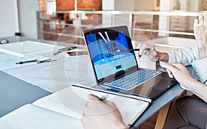 Architect, design engineer or contractor pointing to a 3d digital model on a laptop screen, discussing a plan or idea