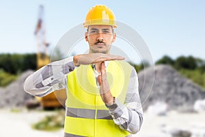 Architect or engineer making time out pause break gesture