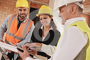 Architect Engineer And Manual Worker Meeting In Construction Site