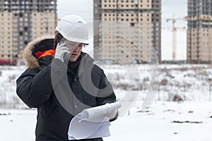 Architect, engineer, project manager or Senior engineer man talking on CB phone to building in the city with a blank