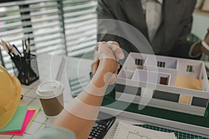 architect and engineer are shaking hand after successfully completing the work, an architect is consulting with an engineer about