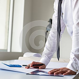 Architect or engineer standing at his office desk