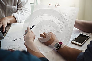 Architect or engineer team working with blueprints building plan design project in office Construction engineering tools and