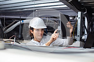 architect engineer woman in hard hat checking construction site ceiling