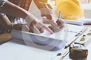 Architect engineer working concept and construction tools or safety equipment on table.