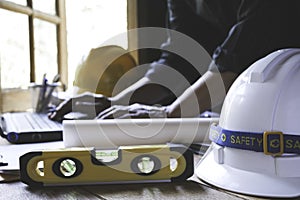 Architect engineer working concept with laptop and construction tools or safety equipment on table