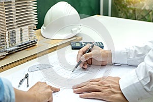 architect or engineer working on table show work man