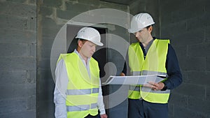 Architect and foreman discussing project at construction site