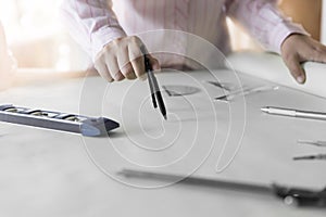 architect hand holding compass working on construction project