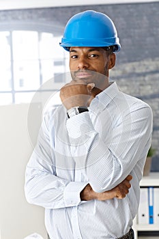 Architect in hardhat thinking