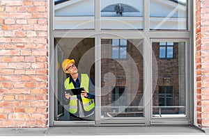 architect in helmet and safety west with tablet pc