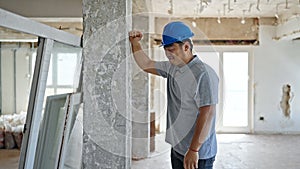 architect hitting wall at construction site