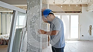 architect hitting wall at construction site