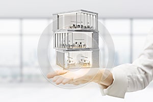 Architect holding business building model