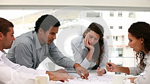 Architect looking at a blueprint map in a meeting