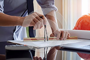 Architect man or male engineer drawing on architectural plan.