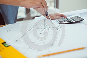 architect man working with laptop and blueprints,engineer inspection in workplace for architectural plan,sketching a construction