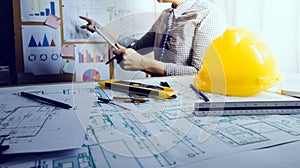 architect man working with laptop and blueprints,engineer inspection in workplace for architectural plan,sketching a construction