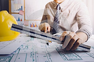 architect man working with laptop and blueprints,engineer inspection in workplace for architectural plan,sketching a construction